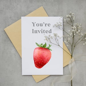 May include: A white card with the text "You're Invited" and a watercolor illustration of a red strawberry.