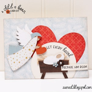 May include: A Christmas card kit with a white angel holding a red heart, a baby in a manger, and the text "Let every heart prepare him room".