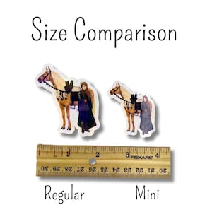 May include: Image comparing the size of two stickers. The stickers depict a woman in a long dress with a horse. The text "Size Comparison", "Regular", and "Mini" are visible. A ruler shows the size difference.