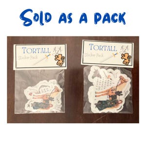 May include: Two sticker packs, each with a clear plastic bag containing stickers. Each pack has a label that reads "TORTALL Sticker Pack" with a sword and a lion logo. The stickers feature illustrations of people and horses.