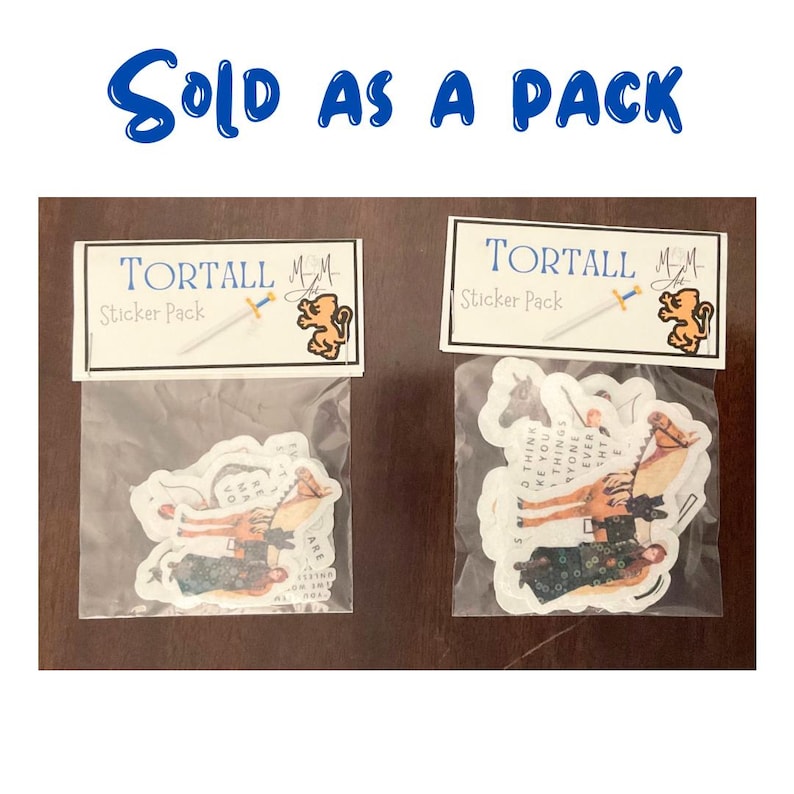 May include: Two sticker packs, each with a clear plastic bag containing stickers. Each pack has a label that reads "TORTALL Sticker Pack" with a sword and a lion logo. The stickers feature illustrations of people and horses.