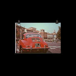 May include: A red vintage Porsche 356 with a number plate that reads "SO 3 8108" parked in a European city square.