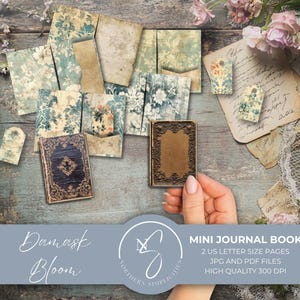 May include: A collection of mini journal books and ephemera with a vintage aesthetic. The books feature ornate covers and are surrounded by floral patterned papers and tags. The color palette includes blues, browns, and creams, with floral accents. The text "Damask Bloom" is visible.
