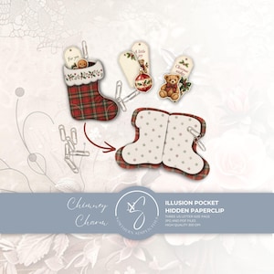 May include: A set of printable papercraft items featuring a red and green plaid Christmas stocking with a white cuff, silver paperclips, and decorative tags with illustrations of a gingerbread man, a teddy bear, and a red ornament with text.