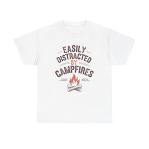 May include: White t-shirt with the text "EASILY DISTRACTED BY CAMPFIRES" in brown lettering. The design includes a stylized campfire graphic with flames and crossed logs, perfect for camping enthusiasts.