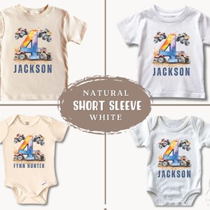 May include: Three white short-sleeved shirts with a watercolor design of monster trucks and the number four. The shirts have the names "Jackson", "Jackson", and "Fynn Hunter" printed on them. The shirts are natural and white.