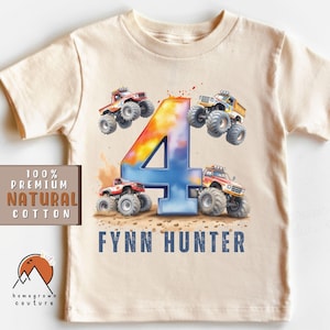 May include: A beige t-shirt with a colorful number four and monster truck graphics. The text "Fynn Hunter" is printed on the shirt.