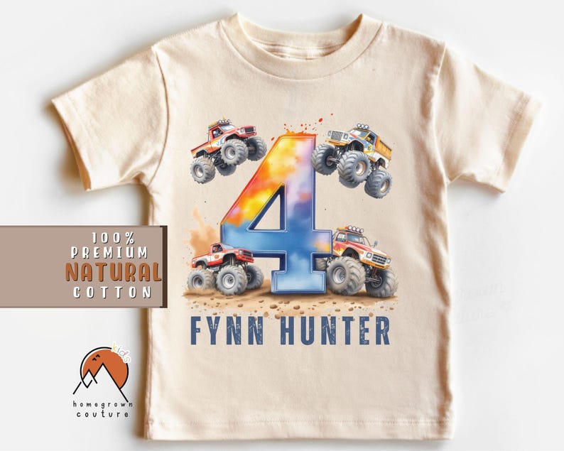 May include: A beige t-shirt with a colorful number four and monster truck graphics. The text "Fynn Hunter" is printed on the shirt.