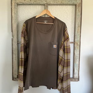 May include: A rustic wooden sign with the text "Welcome to our home" in white lettering. The sign features a distressed finish and a simple, inviting design, perfect for entryway decor.