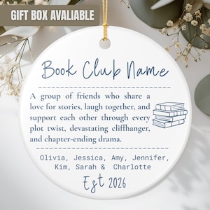 May include: A round white ceramic ornament featuring blue text that reads Book Club Name, followed by a definition of a book club, a stack of books illustration, the names Olivia, Jessica, Amy, Jennifer, Kim, Sarah, and Charlotte, and Est 2026.
