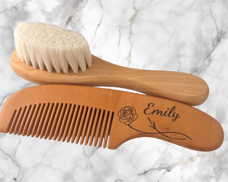 May include: A wooden comb and brush set with a rose design and the name "Emily" engraved on the comb. The set is made of natural wood and has a soft bristle brush.