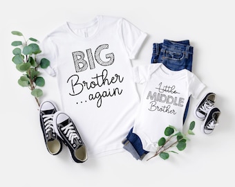 May include: White t-shirt with "BIG Brother...again" text and a white baby onesie with "Little Middle Brother" text. Includes blue jeans, black and white sneakers, and greenery. A matching set for siblings.