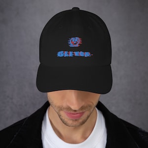 May include: Black baseball cap with a blue and red skull graphic and the text "GLITCH" in a distorted font.