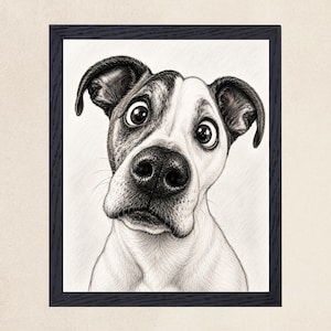 May include: A black and white pencil sketch of a dog with large, wide eyes and floppy ears, captured in a close-up portrait style. The drawing is encased in a dark, textured rectangular frame, highlighting the detailed shading and fur texture.