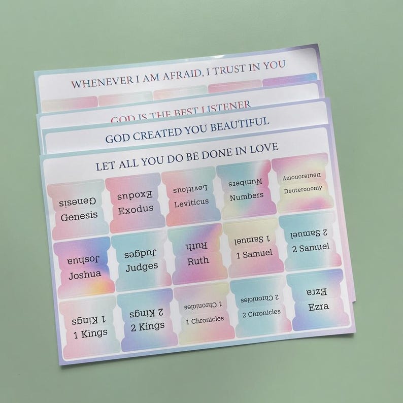 May include: A sheet of adhesive Bible index tabs featuring a pastel gradient background. The tabs are labeled with book names including Genesis, Exodus, Leviticus, Numbers, Deuteronomy, Joshua, Judges, Ruth, 1 Samuel, 2 Samuel, 1 Kings, 2 Kings, 1 Chronicles, 2 Chronicles, and Ezra.