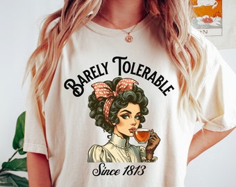 May include: A white t-shirt with a vintage illustration of a woman drinking tea. The text "Barely Tolerable Since 1813" is printed on the shirt.