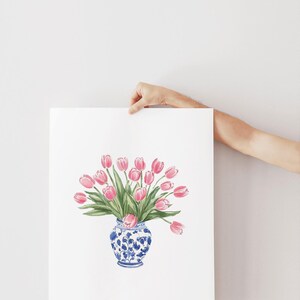 May include: A watercolor painting of a bouquet of pink tulips in a blue and white porcelain vase.