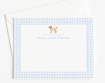 May include: A rectangular white note card with a light blue gingham border and a thin blue inner line. The card features a small illustration of a tan dog and the printed text "from the nursery of Henry James Peterson" in blue ink.