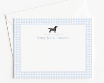 May include: A rectangular stationery card with a light blue and white gingham border, featuring a black dog illustration and the printed text from the nursery of Henry James Peterson, accompanied by a matching white envelope on a plain background.