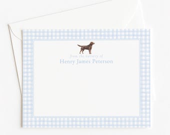 May include: A white stationery card with a light blue gingham border and a thin blue inner frame. The card features a small illustration of a brown Labrador retriever and the printed text "from the nursery of Henry James Peterson".
