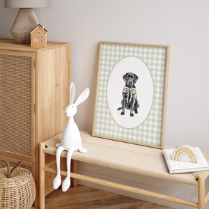 May include: A framed print of a black Labrador Retriever wearing a green bow tie. The print is on a green and white gingham background.
