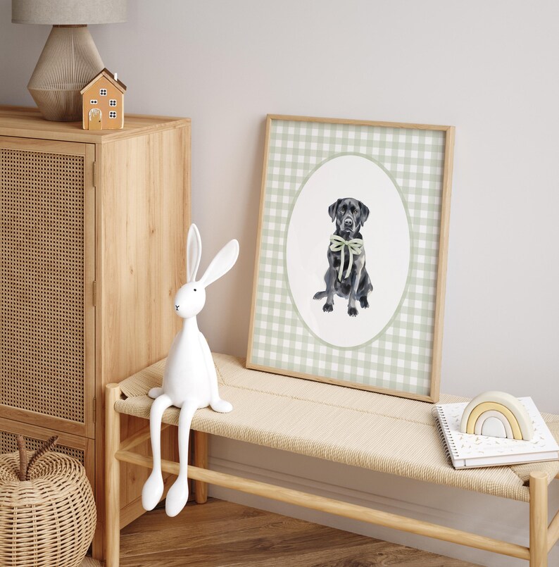 May include: A framed print of a black Labrador Retriever wearing a green bow tie. The print is on a green and white gingham background.