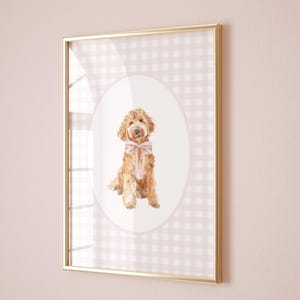 May include: A framed print of a watercolor painting of a brown dog wearing a pink bow, set against a pink and white gingham background.