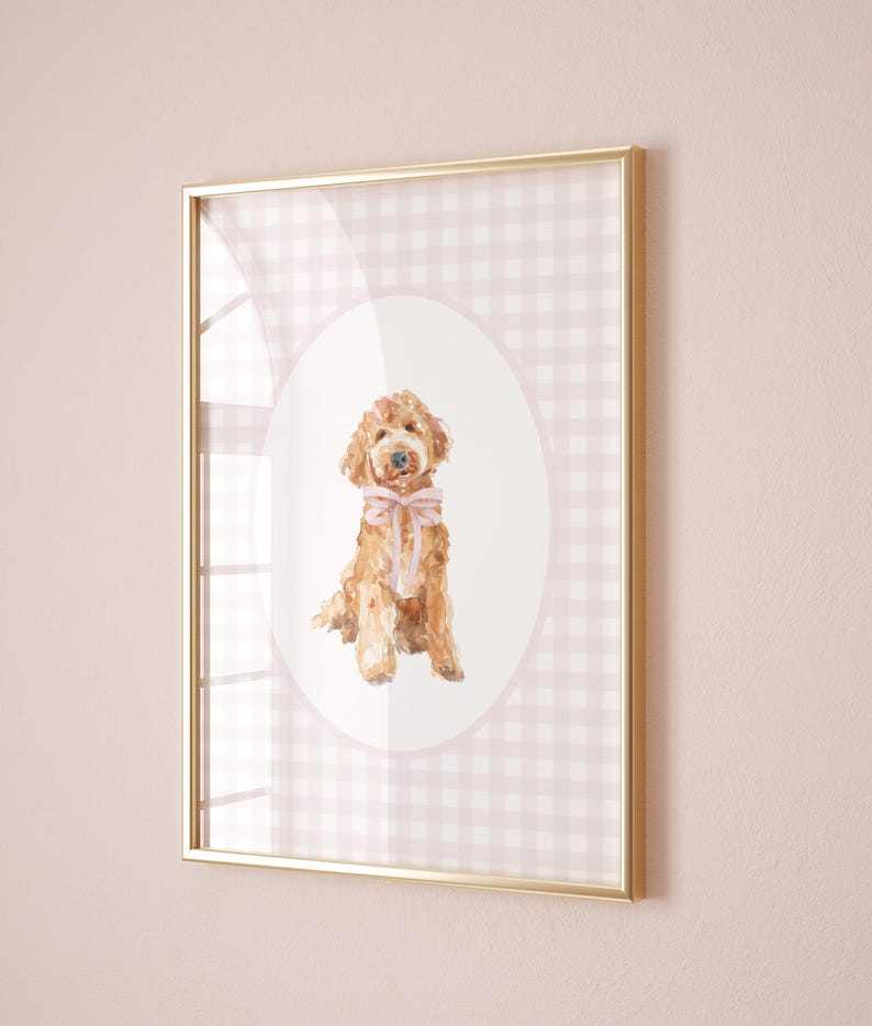 May include: A framed print of a watercolor painting of a brown dog wearing a pink bow, set against a pink and white gingham background.