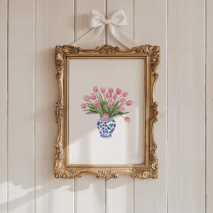 May include: A framed print of a watercolor painting of pink tulips in a blue and white porcelain vase.