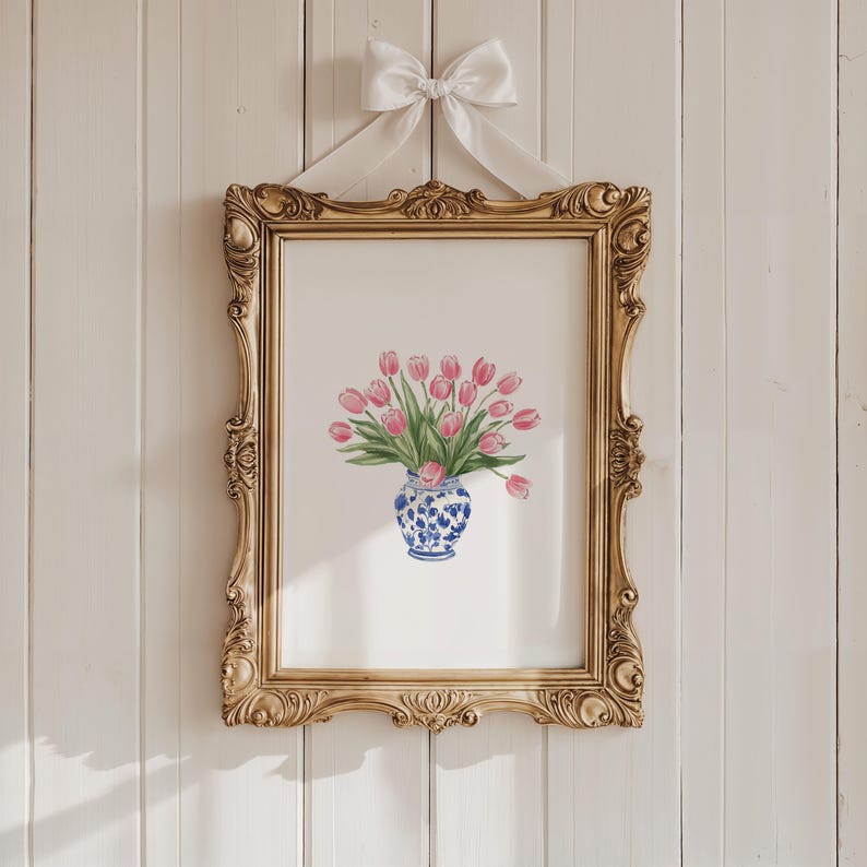 May include: A framed print of a watercolor painting of pink tulips in a blue and white porcelain vase.