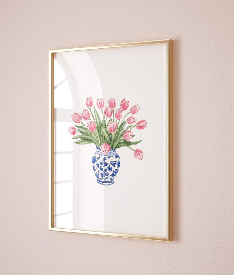 May include: A framed watercolor painting of a bouquet of pink tulips in a blue and white porcelain vase.