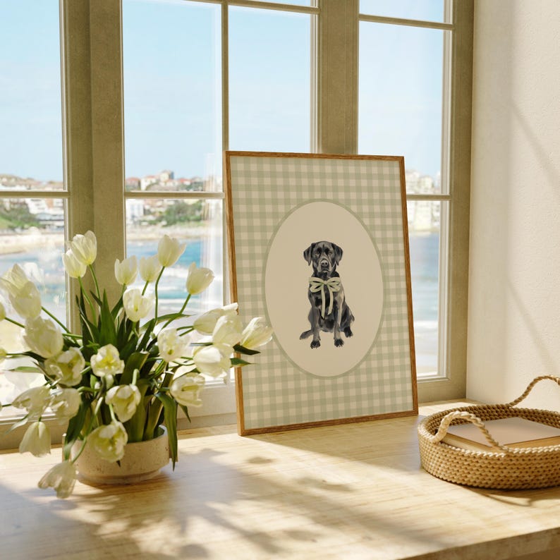 May include: A framed print of a black Labrador Retriever wearing a light green bow tie. The print is on a white and grey gingham background.