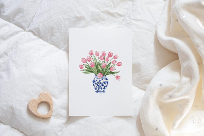 May include: A watercolor painting of a bouquet of pink tulips in a blue and white porcelain vase. The vase has a floral pattern.