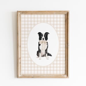 May include: A framed print of a black and white border collie dog wearing a beige bow tie. The print is on a beige and white gingham background.