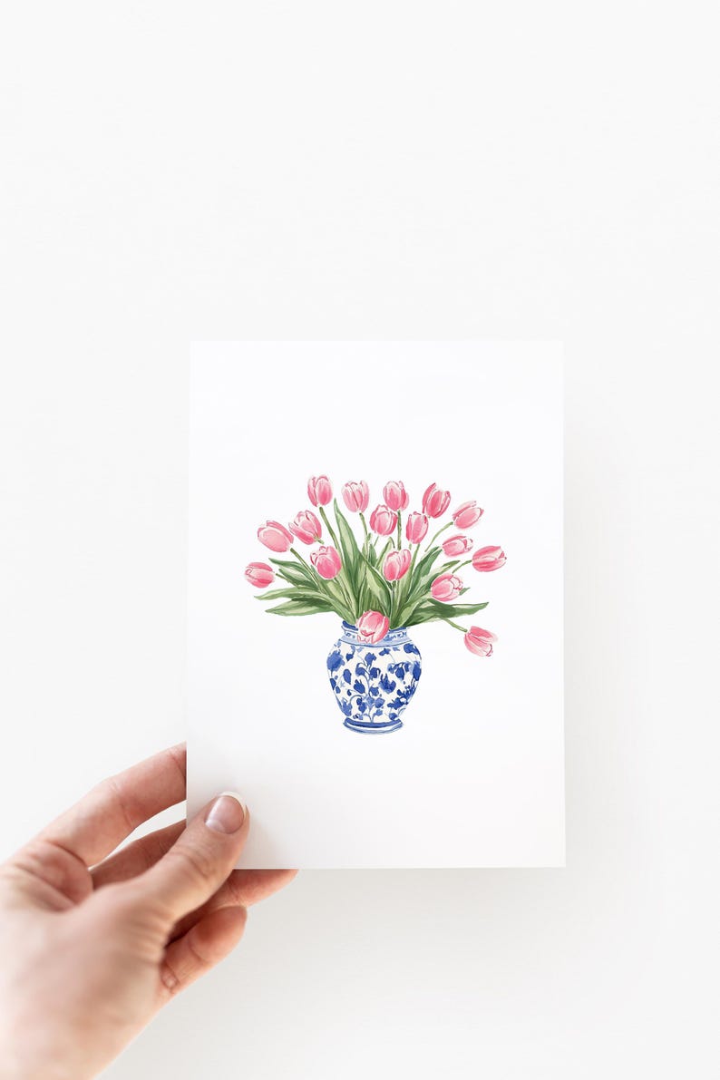 May include: A watercolor painting of a bouquet of pink tulips in a blue and white porcelain vase.