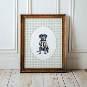May include: A framed print of a black Labrador Retriever wearing a green bow tie. The print is on a green and white gingham background.