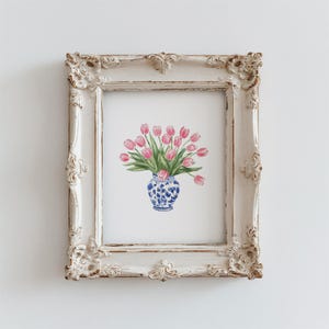 May include: A framed print of a watercolor painting of a bouquet of pink tulips in a blue and white porcelain vase.