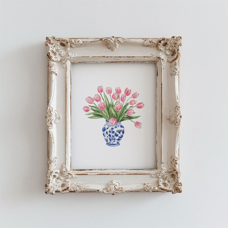 May include: A framed print of a watercolor painting of a bouquet of pink tulips in a blue and white porcelain vase.