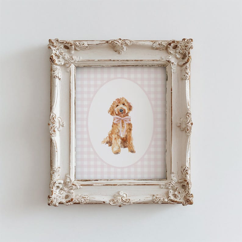 May include: A watercolor painting of a brown dog wearing a pink bow, framed in a white ornate frame with a pink and white gingham background.