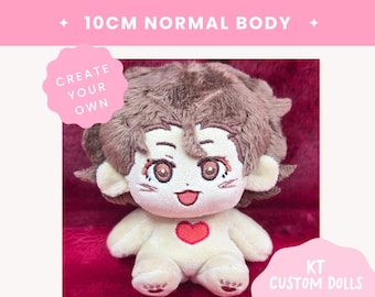 May include: A 10cm plush doll with brown hair, embroidered brown eyes, and a red heart on its chest. The doll has a light skin tone, a smiling mouth, and small paw-like details on its feet. Text on the image reads 10CM NORMAL BODY, CREATE YOUR OWN, and KT CUSTOM DOLLS.