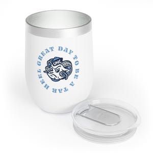 May include: White stainless steel travel mug with a blue and white UNC Tar Heel logo and the text "Great Day To Be A Tar Heel". The mug has a silver lid with a slider.