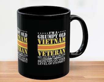 May include: Black ceramic mug with a white handle featuring the text "I'M A GRUMPY OLD VIETNAM VETERAN" in white and yellow lettering. The mug also includes the phrase "MY LEVEL OF SARCASM DEPENDS ON YOUR LEVEL OF STUPIDITY."