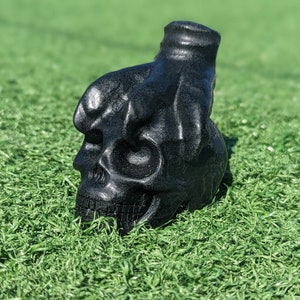 Obsidian Crystal Skull With Clawed Foot.  Skull with Mental health problems, symbol of grip or power over the mind.