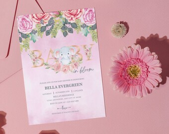 May include: A pink baby shower invitation with a gold "Baby in Bloom" text overlay. The invitation features a watercolor illustration of a pink and white floral garland with a gray elephant holding a pink flower.