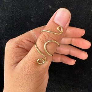 Handmade Brass Adjustable Thumb Ring: Gold Swirl Design