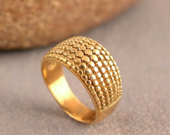 May include: A gold ring with a textured band. The band is made up of rows of small, round beads.