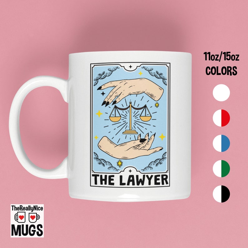 May include: White ceramic mug with a tarot card design featuring a blue background, two hands holding a scale, and the text "THE LAWYER".