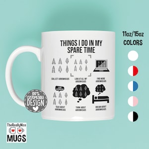 May include: White ceramic mug with a black design that says "Things I do in my spare time" and lists activities related to arrowheads. The mug is 11oz or 15oz and comes in white, red and white, blue and white, pink and white, and black.