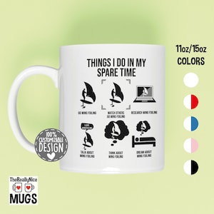 May include: White ceramic mug with a black design that says "Things I do in my spare time" and lists activities related to wing foiling. The mug is available in 11oz or 15oz sizes and in various colors.