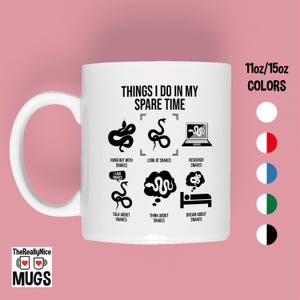 May include: White ceramic mug with a black design that says "Things I do in my spare time" and features a list of activities related to snakes. The mug is available in 11oz or 15oz sizes.